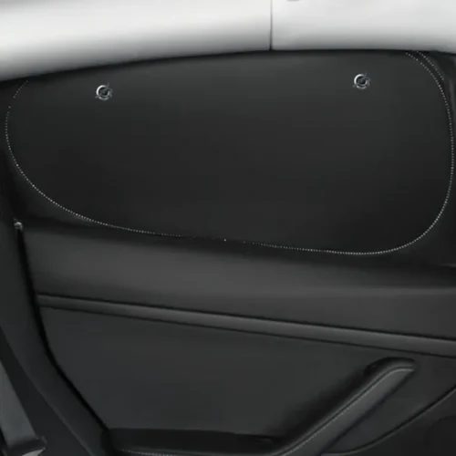 Car interior door with a large black speaker panel outlined by white dotted stitching and two round fasteners.