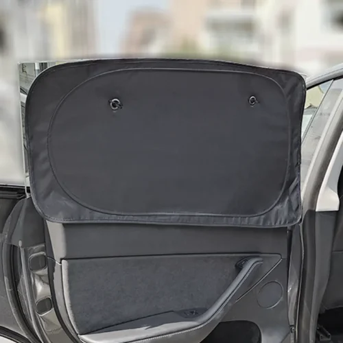Back seat door with a large black privacy sunshade pulled up over the window, attached near the top.