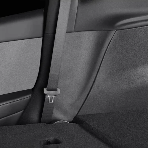 Gray seat belt hanging over a car's rear seat, with buckle visible