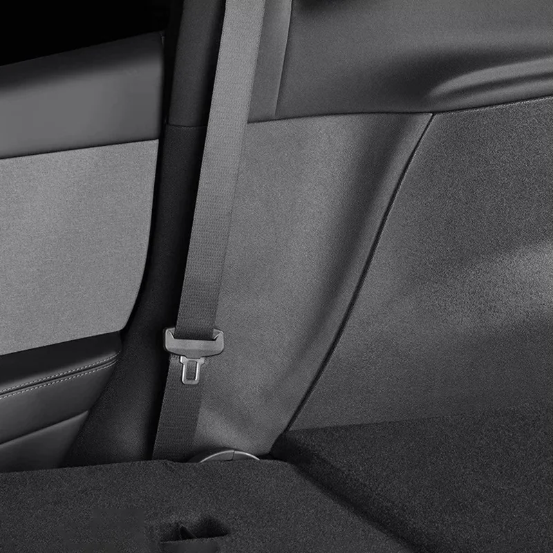 Gray seat belt hanging over a car's rear seat, with buckle visible
