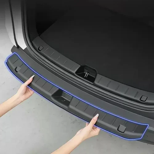Person placing a curved trunk sill guard along the car’s rear opening, outlined in blue for visibility