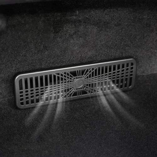 Rectangular ventilation grille mounted on a dark fabric surface, with a central hub and radial spokes.