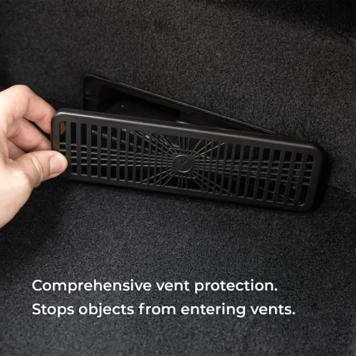 Hand placing a rectangular black vent grille to block debris from entering a vehicle vent (overlay text reads: 'Comprehensive vent protection. Stops objects from entering vents.').