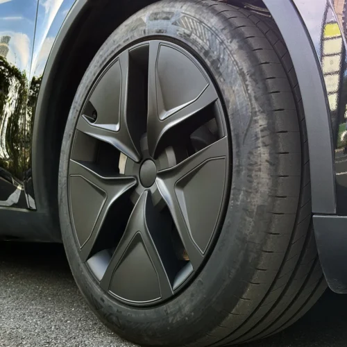 Close-up of a car wheel with a large matte gray alloy rim and low-profile tire.