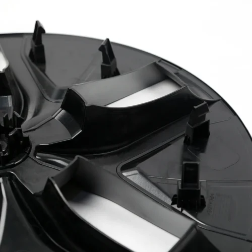 Close-up of a black circular plastic mounting base with multiple clip tabs for attachment.