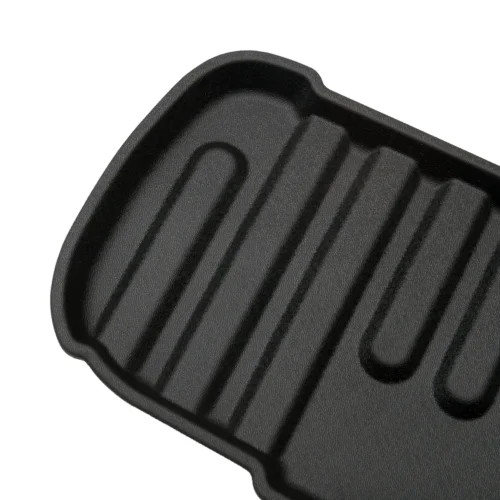 Close-up of a black ridged grill pan surface designed for searing grill marks on foods