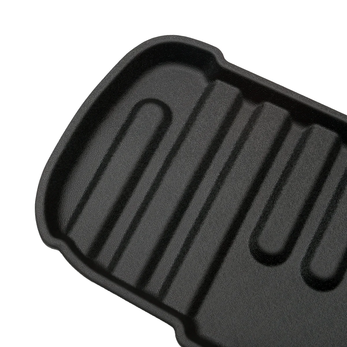 Close-up of a black ridged grill pan surface designed for searing grill marks on foods